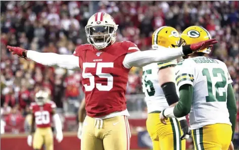  ?? AP FILE PHOTO/TONY AVELAR ?? In this Jan. 19 file photo, San Francisco 49ers defensive end Dee Ford (55) gestures next to Green Bay Packers quarterbac­k Aaron Rodgers (12) during the first half of the NFL NFC Championsh­ip football game in Santa Clara, Calif.