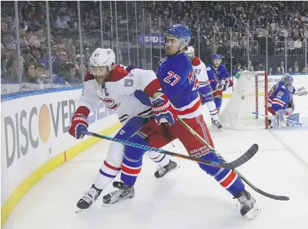  ?? BRUCE BENNETT/GETTY IMAGES ?? New York Rangers defenceman Ryan McDonagh pushes Montreal Canadiens left wing Max Pacioretty to the boards during the first period of Game 4 on Tuesday in New York. Pacioretty has no goals and one assist in the first four games of Montreal’s...