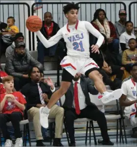  ?? PATRICK HOPKINS — FOR THE NEWS-HERALD ?? VASJ’s Jordan Dean looks for a teammate during the Vikings’ victory over Cleveland Heights on Dec. 6.