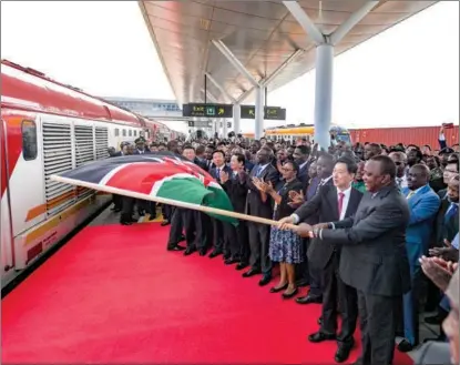  ?? LI YAN / XINHUA ?? Kenyan President Uhuru Kenyatta and State Councilor Wang Yong, the special envoy of President Xi Jinping, commission the freight operation of the Chinese-built Nairobi-Naivasha Standard Gauge Railway in Nairobi on Dec 17.