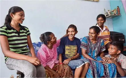  ??  ?? What a feeling!: A happy Nisanthiny (third from left) enjoying some quality time with her family members.