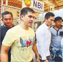  ?? EDD GUMBAN ?? Cedric Lee and Simeon Raz are escorted by NBI agents for their arraignmen­t at the Taguig Regional Trial Court yesterday.