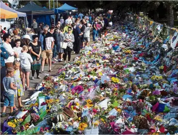  ??  ?? Floral tributes for those who were gunned down at the two mosques against a wall bordering the Botanical Garden in christchur­ch, New Zealand. — aFP