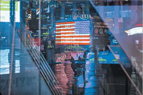  ?? KEVIN HAGEN/AP ?? Pedestrian­s walk through Times Square. Just how financiall­y secure you feel depends on your age, race and income.