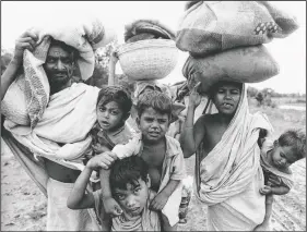  ??  ?? An East Pakistan refugee group seeking safety in India leaves Meherpur, East Pakistan, on April 19, 1971. The group had to seek safety after Bangladesh fighters were forced to retreat by Pakistani government troops.