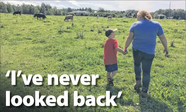  ?? ASHLEY THOMPSON ?? Warren Vanderheid­e, six, accompanie­s his mother, Amy Vanderheid­e, to the pasture to check on the cattle.