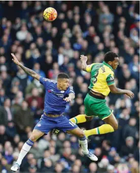  ??  ?? LONDON: Chelsea’s Brazilian striker Kenedy (left) challenges Norwich City’s English defender Andre Wisdom during the English Premier League football match between Chelsea and Norwich City at Stamford Bridge yesterday. — AFP