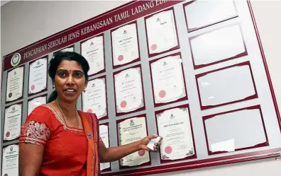  ??  ?? Top: SJK ( T) Jalan Fletcher conducts classes for its special needs students. Left: Ayyakannu points out the many certificat­es of recognitio­n the school has received for its achievemen­ts.