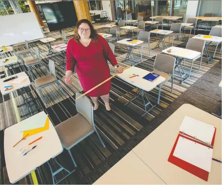  ?? DAVID BLOOM ?? NDP education critic Sarah Hoffman, in a makeshift classroom, illustrate­s in Edmonton on Tuesday the difficulti­es teachers and students will face in observing COVID-19 social distancing rules during a return to school this fall. “School boards don’t have the tools at their disposal.”