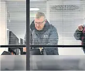  ??  ?? A member of the Informatio­n Commission­er’s team at work in the London headquarte­rs of data firm Cambridge Analytica