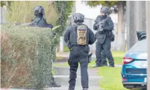  ?? Photo / Mark Mitchell ?? Police armed offenders squad members in Levin.