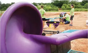  ?? PHOTOS BY JIM BECKEL,
THE OKLAHOMAN ?? About 140 volunteers from Partners in Public Health, Blue Cross and Blue Shield of Oklahoma, KaBOOM! and community residents worked Saturday to create a new playground at the Northeast Regional Health and Wellness Center on NE 63 Street, east of Martin...