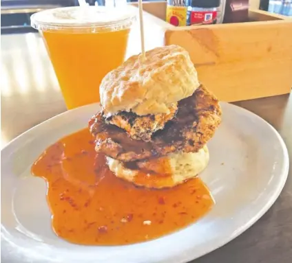  ?? PHOTO BY SUSAN PIERCE ?? The Squawking Goat at Maple Street Biscuit Company fills a house-made biscuit with fried chicken breast and goat cheese. Fresh-squeezed orange juice completed the order.
