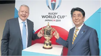  ?? AP ?? Japanese Prime Minister Shinzo Abe, right, and World Rugby chief Bill Beaumont pose with The Webb Ellis trophy in Kyoto.
