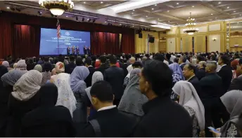  ?? — Bernama photo ?? Civil servants listen as Anwar delivers his address at the Prime Minister’s Department’s monthly assembly in Putrajaya.
