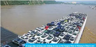  ?? — AFP ?? A cargo ship carrying cars making its way on the Yangtze River in Yichang in China’s central Hubei province.