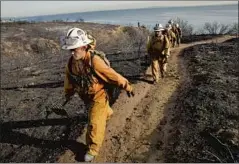  ?? Ted Soqui Corbis ?? WOMEN from Malibu Camp No. 13 helped extinguish the Malibu Road fire on Jan. 8, 2007. They were on the job for more than 24 hours stomping out hot spots.