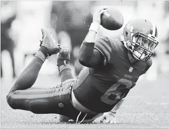  ?? JOE ROBBINS GETTY IMAGES ?? Quarterbac­k Baker Mayfield of the Browns hits the ground after being tripped in the third quarter against the Baltimore Ravens in Cleveland. The Browns improved to 2-2-1 thanks to a 12-9 overtime victory.