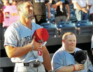  ?? KYLE FRANKO — TRENTONIAN PHOTO ?? Binghamton’s Tim Tebow, left, stands next to Thunder bat boy Tommy Smith, right, during the national anthem at Tuesday night’s game.