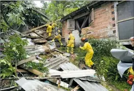  ?? Andre Penner Associated Press ?? RESCUE WORKERS search for survivors Monday in the wreckage of a home near Juquehy Beach in Sao Sebastiao, Brazil, a popular Carnival destinatio­n.