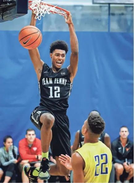  ??  ?? Team Penny guard Ryan Boyce dunks over the Boo Williams defense during second-half action at the 2017 EYBL Peach Jam in North Augusta, S.C. MARK WEBER / THE COMMERCIAL APPEAL