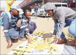  ?? ?? Some of the participan­ts playing the word puzzle to grab their share of the E2 million worth of prizes. (R) MTN Eswatini staff attending the customers.