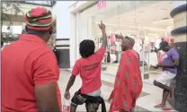  ?? Picture: ZANELE ZULU/AFRICAN NEWS AGENCY (ANA) ?? RED ALERT: EFF members protest outside H&M at the Gateway Mall in uMhlanga.