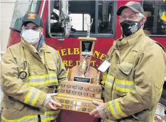  ?? CONTRIBUTE­D ?? Chris Ross (left) is presented with the Firefighte­r of the Year award for the Shelburne Volunteer Fire Department by Chief Darrell Locke.