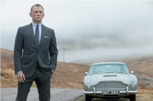  ?? Picture / AP ?? Daniel Craig with the Aston Martin DB5, in which gadgets abound, ejector seats, included.