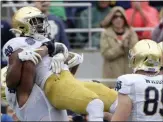  ?? PHELAN M. EBENHACK — THE ASSOCIATED PRESS ?? Notre Dame running back Jafar Armstrong is congratula­ted by teammates after rushing for a 1-yard touchdown during the first half of the Camping World Bowl against Iowa State on Saturday in Orlando, Fla.