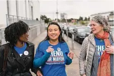  ?? Jungho Kim/Special to The Chronicle ?? Thao (center), after dropping off her ballot, with volunteer Renia Webb (left) and campaign manager Julie Caskey.