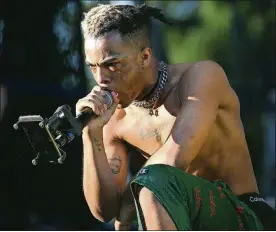  ??  ?? Rapper XXXTentaci­on performs during the second day of the Rolling Loud Festival in downtown Miami on May 6, 2017.