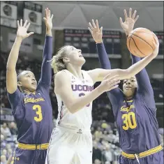  ?? STEPHEN DUNN — THE ASSOCIATED PRESS ?? UConn’s Katie Lou Samuelson puts up a shot between Cal’s Mikayla Cowling, left, and CJ West. Samuelson suffered a foot injury and had to leave the game.