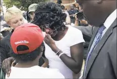  ?? Steve Ruark/Associated Press ?? Gloria Darden, center, the mother of Freddie Gray, wipes away tears Wednesday at a news conference held by Baltimore attorney Marilyn Mosby.