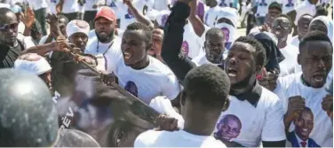  ?? Associated Press ?? ↑
Supporters of Jovenel Moise protest outside the former leader’s family home in Cap-haitien on Friday.