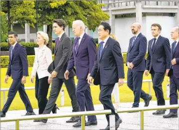  ?? SUSAN WALSH AP ?? Leaders of the G7 walk to a wreath-laying ceremony at the Hiroshima Peace Memorial Park in Hiroshima, Japan, on Friday as part of their summit, which will continue through the weekend.