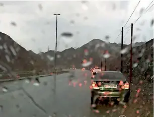  ??  ?? A view of Al Dhaid-Kalba Road drenched in rain on Friday morning. Light to moderate rains were reported from different parts of the UAE. —