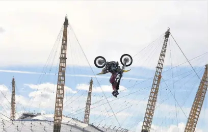  ??  ?? American profession­al motorsport­s competitor and stunt rider Travis Pastrana performs back-flips on a motorcycle between two floating barges in the River Thames, ahead of the opening at the Birmingham Arena in November of ‘Nitro Circus: You Got This’,...