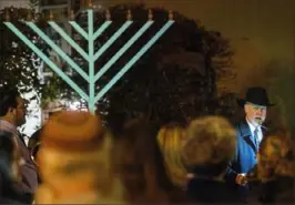  ?? Stephanie Strasburg/Post-Gazette ?? Rabbi Jeffrey Myers of Tree of Life/Or L’Simcha Congregati­on speaks Sunday as he announces the lighting of the menorah for the first day of Hanukkah outside the Tree of Life synagogue in Squirrel Hill.