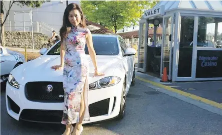  ??  ?? SunCom VP Julia Lau poses in front of luxury vehicles lined up at a SunCom event, at Edgewater Casino. In Sun Commercial advertisin­g materials, Lau trumpeted her internatio­nal network of wealthy buyers, and $560 million worth of luxury residence sales prior to forfeiting her realtor license in 2015.