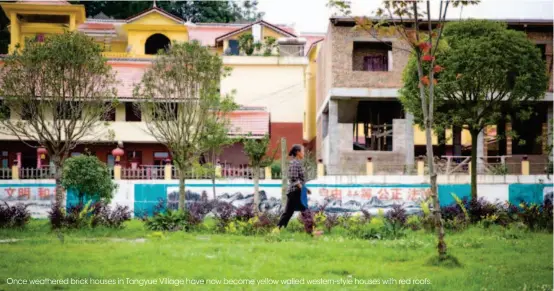  ??  ?? Once weathered brick houses in Tangyue Village have now become yellow walled western-style houses with red roofs.