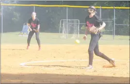  ?? STAFF PHOTO BY TED BLACK ?? North Point High School hurler Gabby Edison delivers to the plate in the bottom of the second inning on Monday afternoon at Calvert High School while sophomore shortstop Katie Delph looks on. Edison and Delph eventually switched places on the field as...