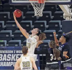  ?? Ronald Cortes / Associated Press ?? Georgia Tech forward Lorela Cubaj (13) scores on a reverse layup past Stephen F. Austin forward Avery Brittingha­m.