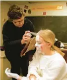  ?? BALTIMORE SUN 1999 ?? Roland Park Country School art teacher Judy Waters, left, sprays Elizabeth Brushart’s hair white in preparatio­n for a Christmast­ime performanc­e.