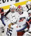  ?? Jeff McIntosh / Associated Press ?? Goaltender Nicole Hensley (center) celebrates with U.S. teammates after shutting out Finland 3-0 in a semifinal.