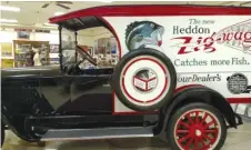  ?? DALE BOWMAN/FOR THE SUN-TIMES ?? Clockwise, from top: The outside of the Heddon Museum in Dowagiac, Michigan. The restored Dodge combines the Lyons’ love of restoring vehicles and Heddon memories. The case of the end of the line of Heddon lures from Dowagiac.