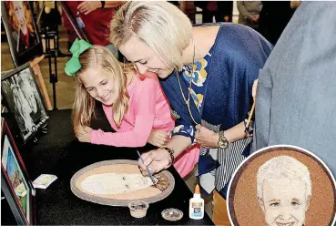  ?? [PHOTOS PROVIDED] ?? ABOVE: Addison Hooper, Aidan Hooper’s little sister, and Susannah Hooper, Aidan’s mother, apply the finishing touches to the floragraph of Aidan. RIGHT: Here is the finalized floragraph of Aidan Hooper.