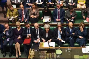  ?? AP/MARK DUFFY ?? Britain’s Prime Minister Theresa May (center) addresses lawmakers’ concerns about her European Union deal Wednesday in the House of Commons in London.