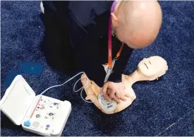  ?? AP ?? An exhibitor demonstrat­es a portable defibrilla­tor before the start of the Consumer Electronic­s Show in Las Vegas in January.