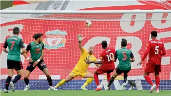  ?? AFP ?? Liverpool’s Senegalese striker Sadio Mane (third from right) shoots past Aston Villa goalkeeper Pepe Reina to score the opening goal during their English Premier League football match at Anfield in Liverpool, North West England, on Sunday. Liverpool carved out a 2-0 victory. —